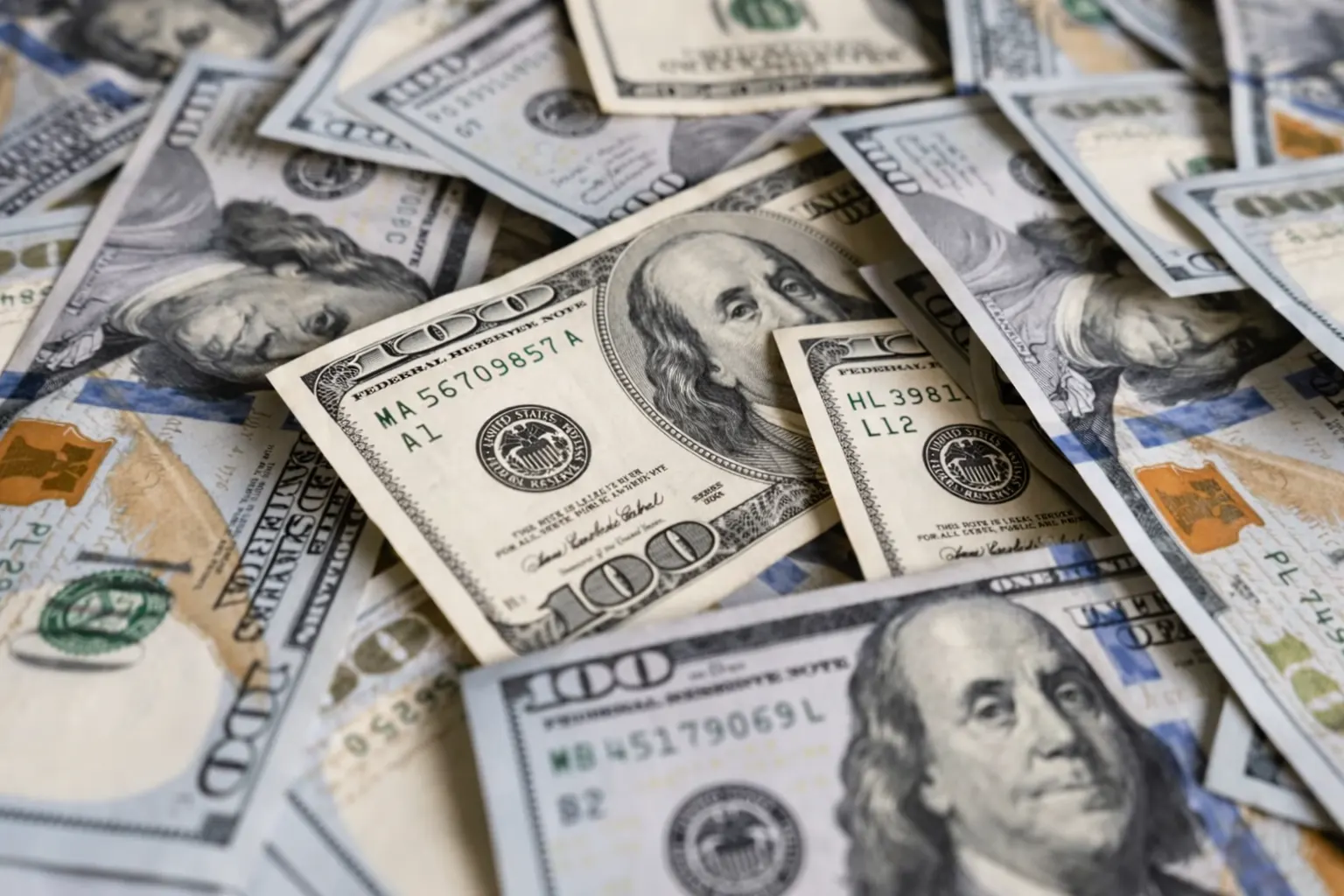 Stacks of US dollar bills representing a plan to pay off ten thousand dollars of debt